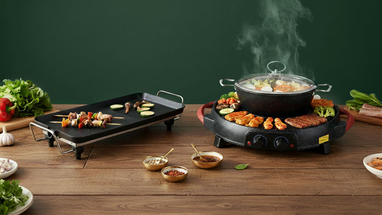 Table with electric griddle and pot on a wooden surface with ingredients and condiments.